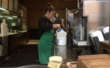 Gourmet coffee attendant serves up diverse drinks to diverse customers